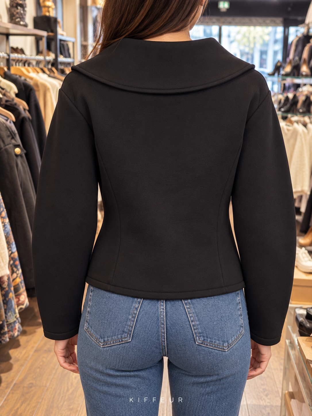 Veste courte noire à grand col, portée de dos en boutique KIFFEUR